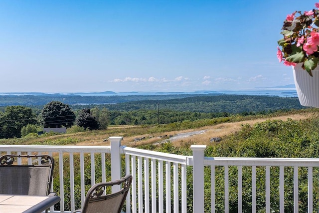 balcony featuring a wooded view