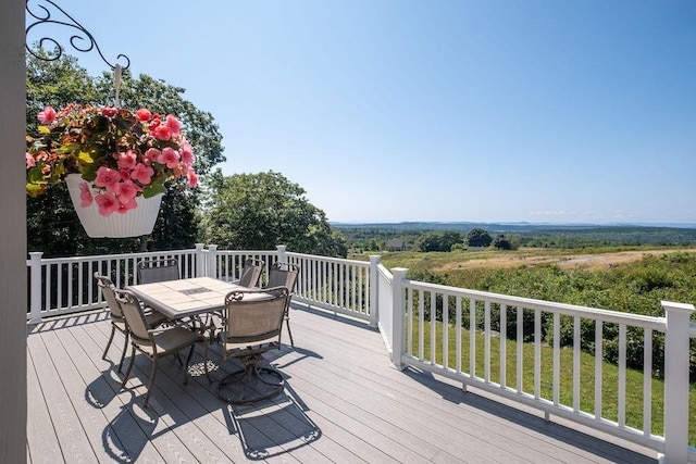 wooden deck featuring outdoor dining area