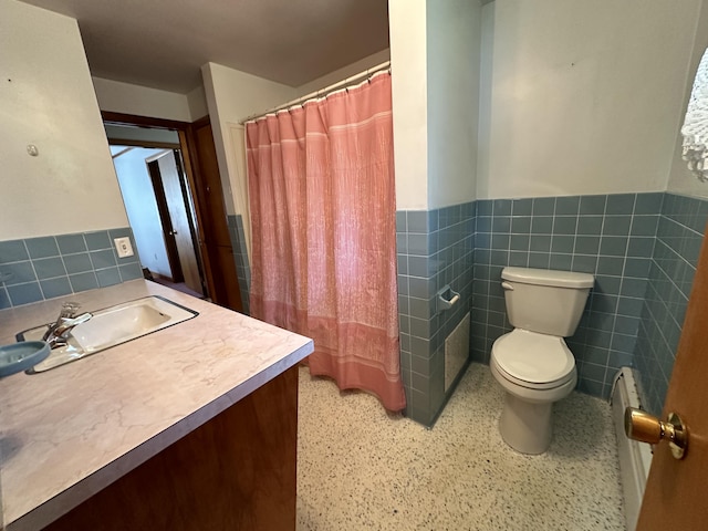 bathroom featuring tile walls, toilet, and vanity