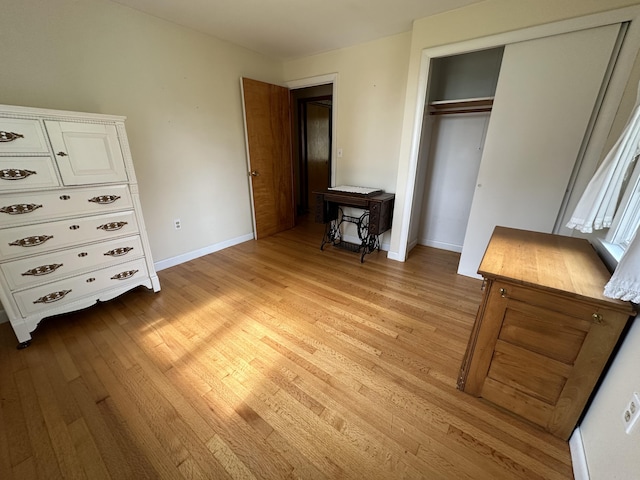 bedroom with a closet and light hardwood / wood-style floors