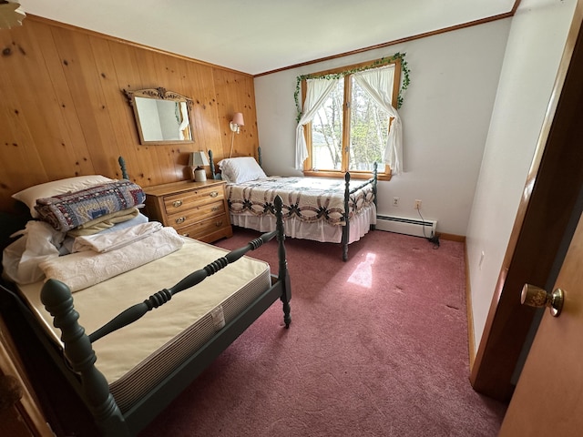 bedroom with baseboard heating, ornamental molding, dark carpet, and wooden walls