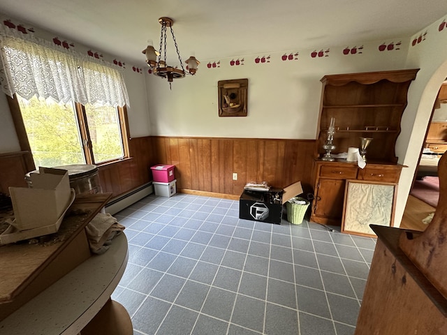 sitting room with light tile patterned flooring, a baseboard heating unit, and an inviting chandelier