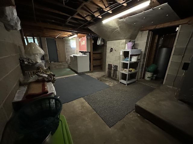 basement featuring washing machine and clothes dryer and gas water heater