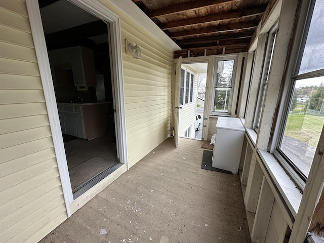 unfurnished sunroom with wood ceiling