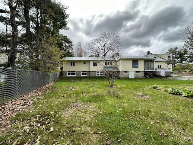 rear view of house with a lawn