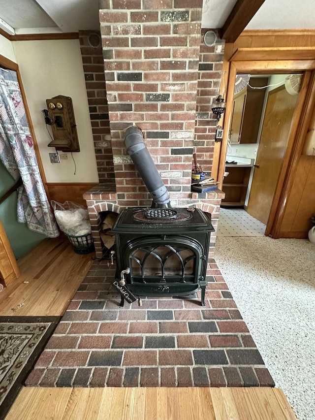 room details featuring a wood stove and wood walls