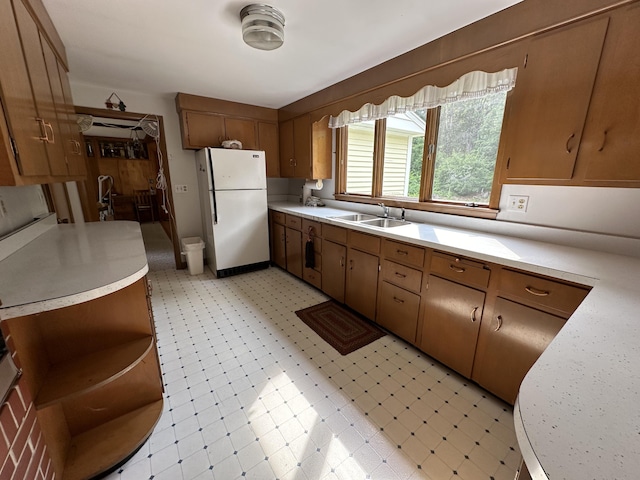 kitchen featuring white refrigerator and sink