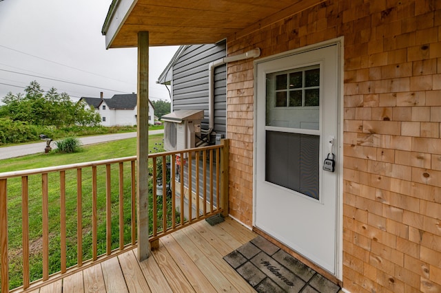 wooden terrace with a lawn