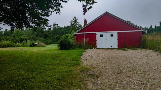 view of outbuilding featuring a lawn