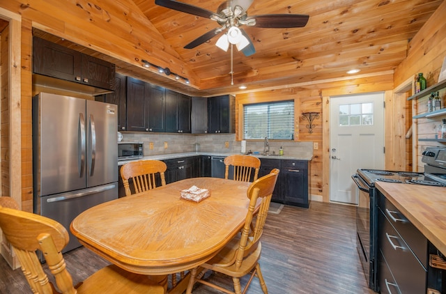 kitchen with lofted ceiling, wood ceiling, dark brown cabinets, dark hardwood / wood-style flooring, and black appliances