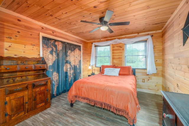 bedroom with dark hardwood / wood-style floors and wooden ceiling