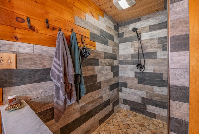 bathroom with a tile shower and wooden ceiling