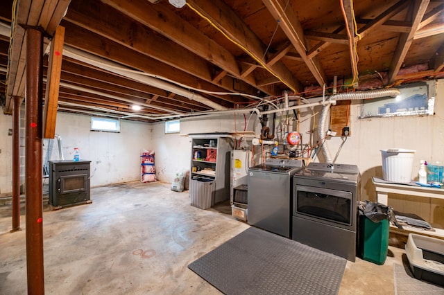 basement with water heater and separate washer and dryer