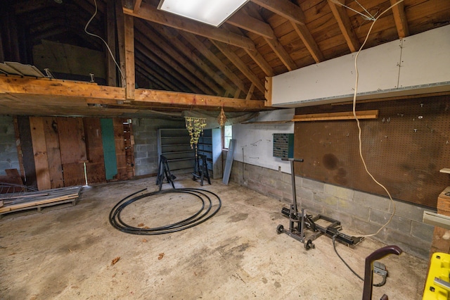 miscellaneous room with lofted ceiling and concrete floors