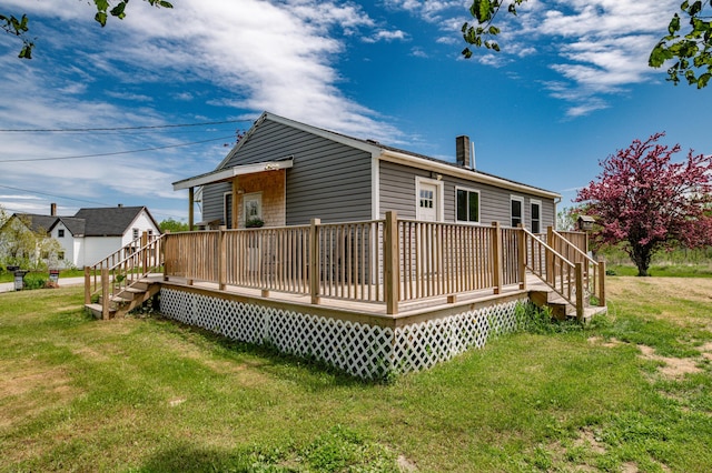 14 Porter St, Searsport, ME 04974 - back of property with a lawn, a deck, a chimney, and stairs