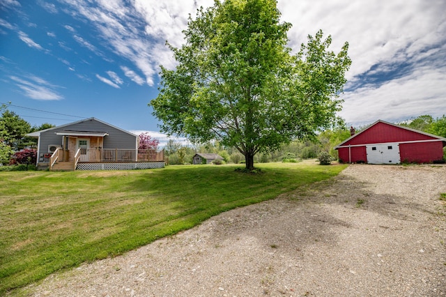 14 Porter St, Searsport, ME 04974 - view of green lawn with a deck, a detached garage, and an outbuilding