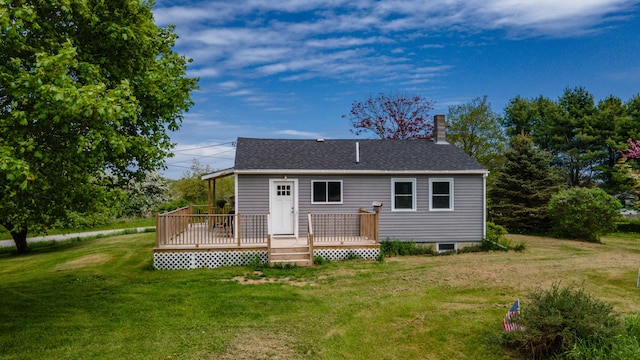14 Porter St, Searsport, ME 04974 - back of property with a lawn, a wooden deck, a chimney, and roof with shingles