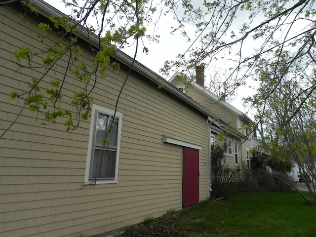 view of property exterior with a lawn