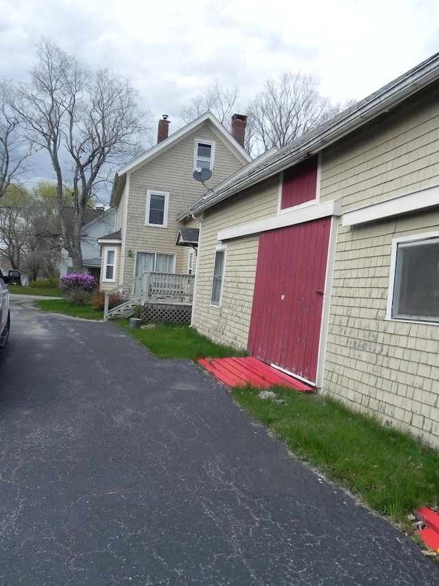 view of side of property featuring a wooden deck