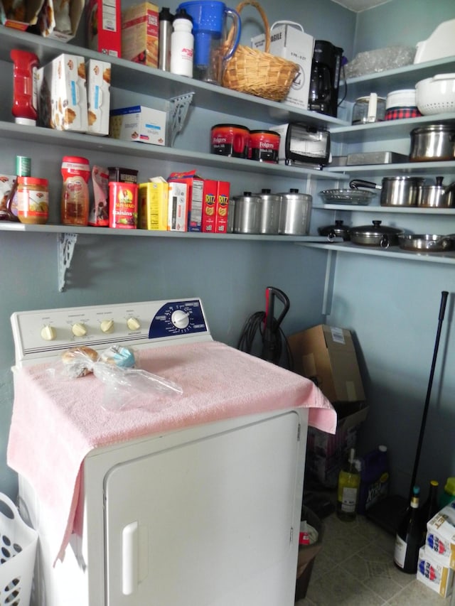 clothes washing area with tile flooring and washer / dryer