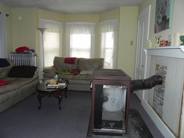 carpeted living room featuring radiator heating unit and a high end fireplace