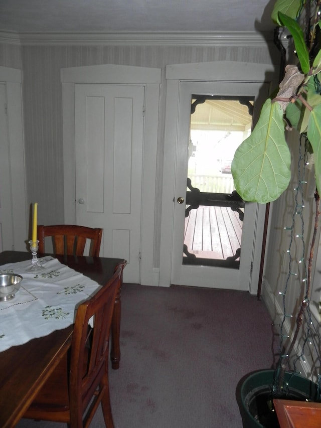 dining space with ornamental molding and carpet floors