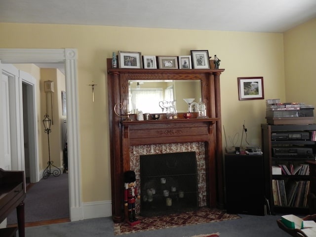 living room featuring a fireplace and carpet flooring