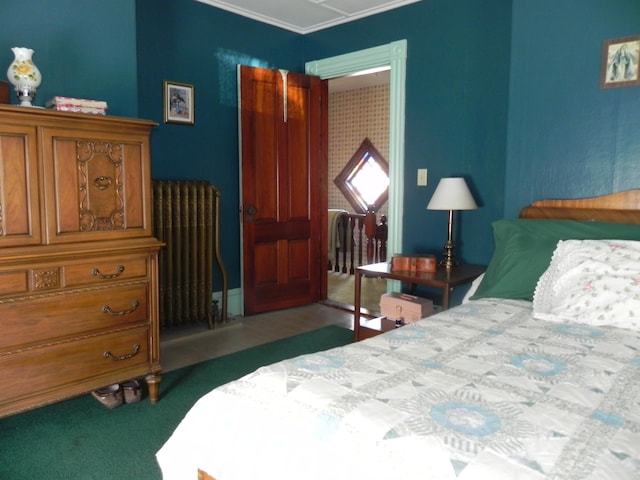 carpeted bedroom featuring radiator and crown molding