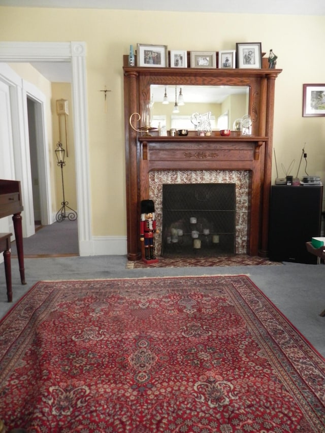 living room with carpet floors and a high end fireplace