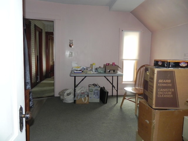 interior space with carpet flooring and vaulted ceiling