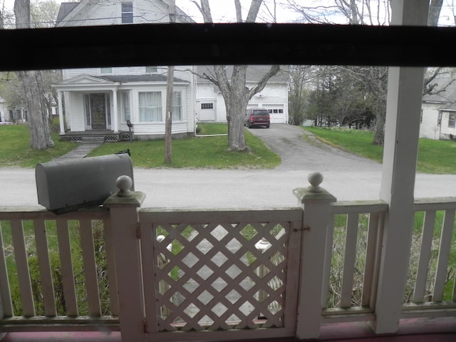 view of gate with a yard