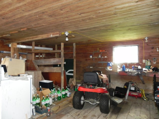 interior space featuring wooden walls, a workshop area, and wood ceiling