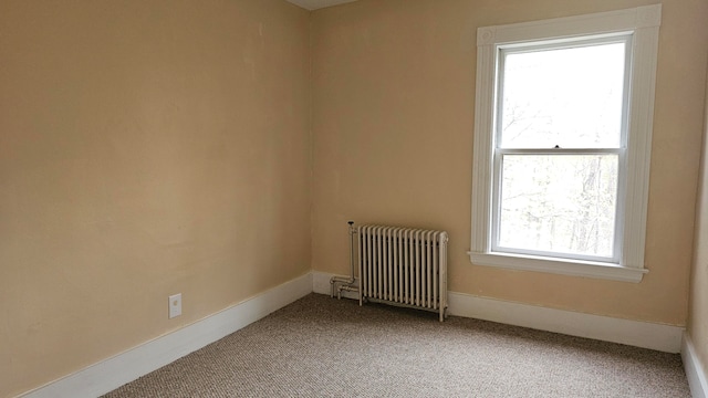 empty room with radiator and carpet floors