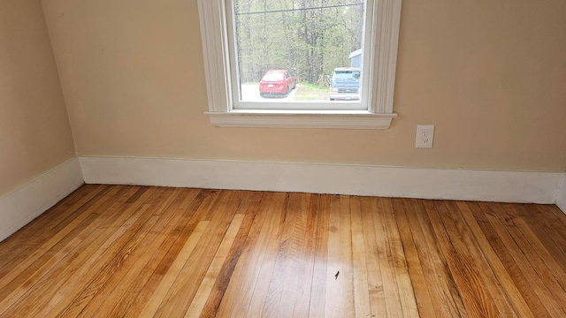 unfurnished room with wood-type flooring