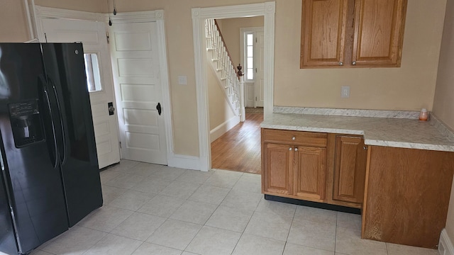 kitchen with black fridge and light hardwood / wood-style floors