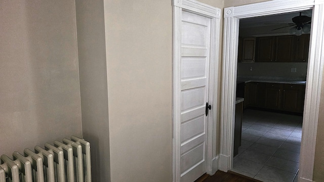 corridor with radiator heating unit and tile patterned flooring