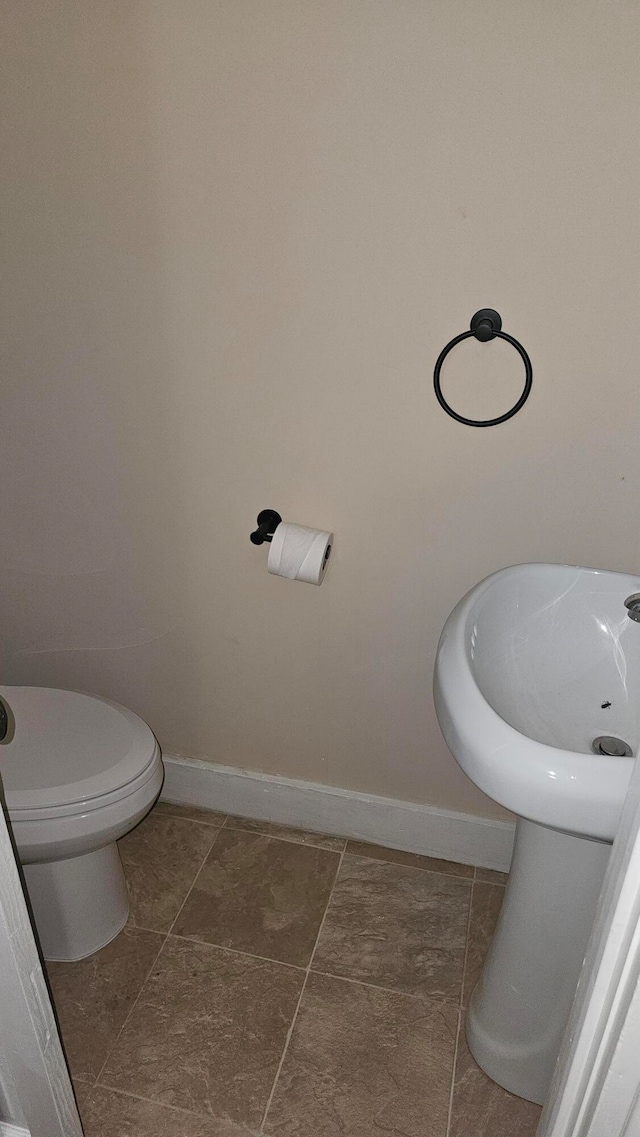 bathroom featuring toilet and tile patterned floors