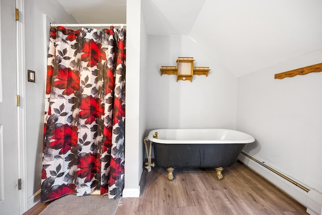 bathroom featuring vaulted ceiling, a baseboard radiator, and hardwood / wood-style flooring