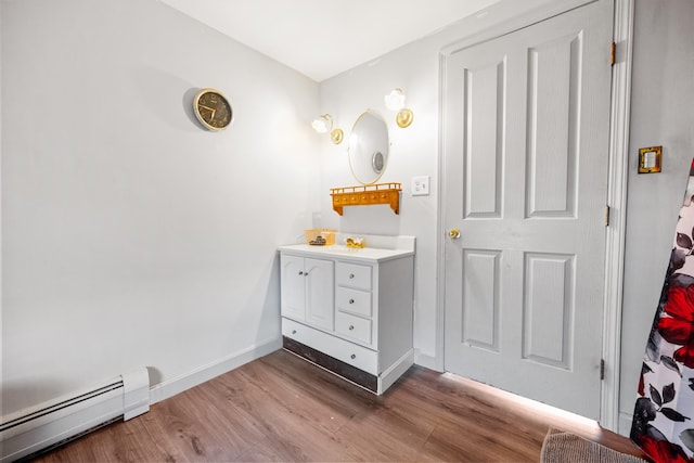 bathroom with baseboard heating, vanity, and hardwood / wood-style flooring