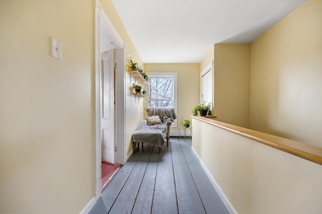 hall featuring a baseboard heating unit and hardwood / wood-style flooring