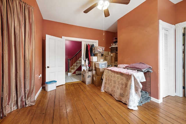 bedroom with a closet, wood-type flooring, and ceiling fan