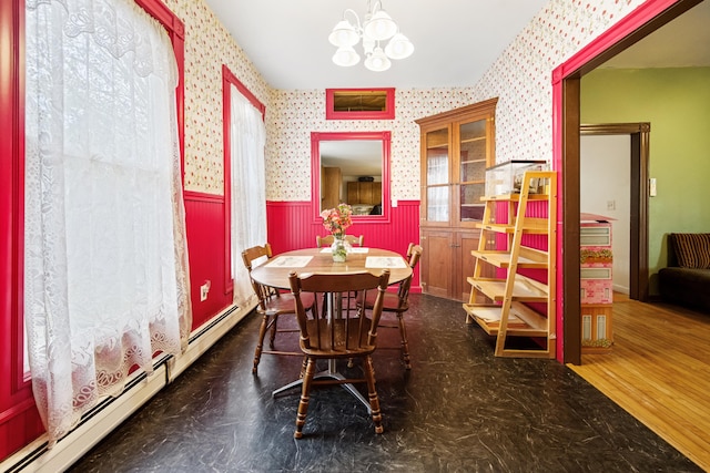 dining room with a notable chandelier, hardwood / wood-style flooring, and a baseboard radiator