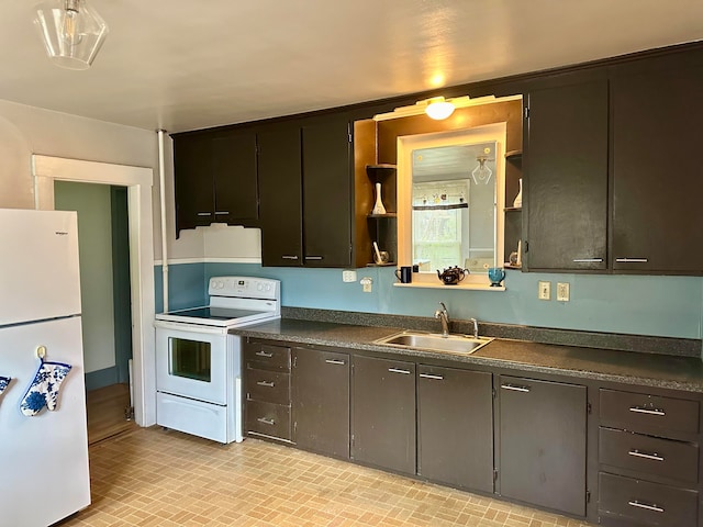 kitchen with dark brown cabinets, sink, and white appliances