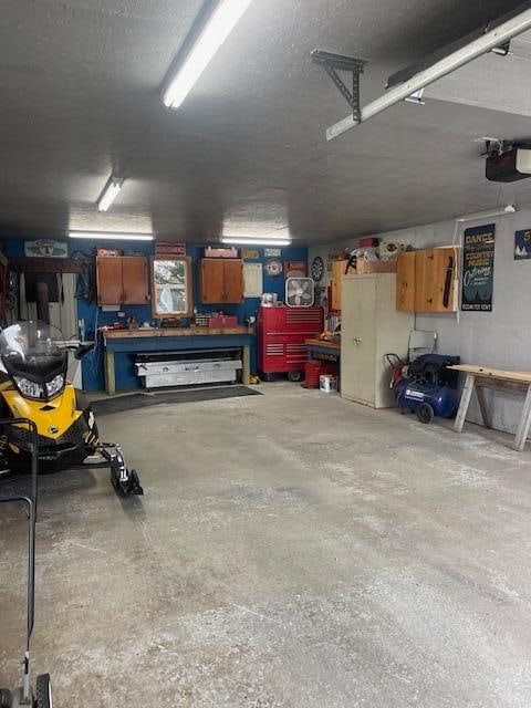 garage featuring a garage door opener and a workshop area