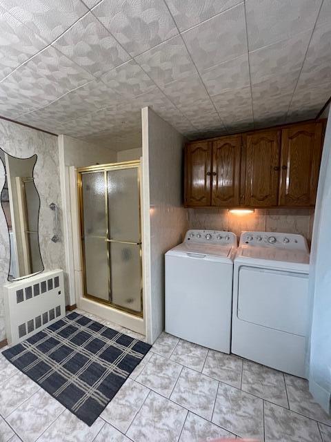 laundry area featuring radiator and washing machine and dryer