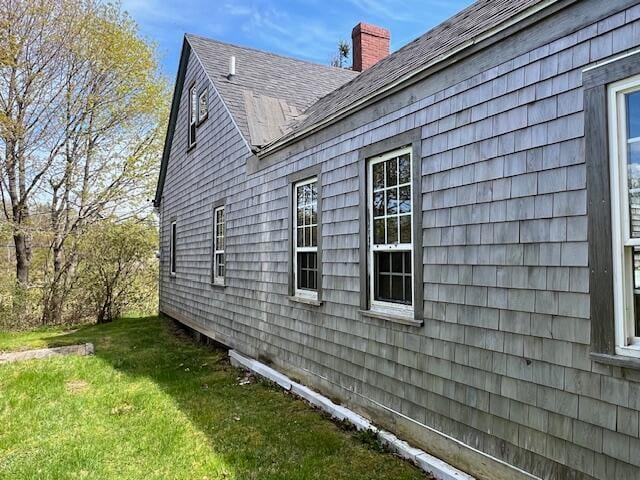 view of home's exterior with a lawn