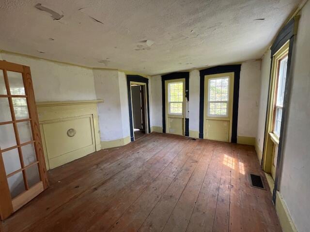 spare room with hardwood / wood-style flooring and a textured ceiling