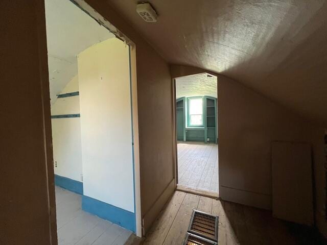 bonus room featuring vaulted ceiling and hardwood / wood-style floors