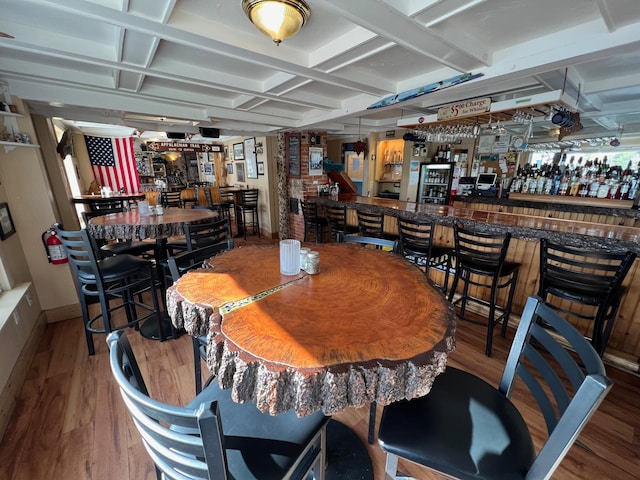 9 Tenney Hill Rd, Monson, ME 04464 - dining space with coffered ceiling, wood-type flooring, and bar