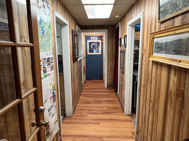 9 Tenney Hill Rd, Monson, ME 04464 - corridor with wooden walls and light wood-type flooring